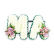 In this photograph, a refined funeral floral tribute spells out the word MA in large, sculpted letters, designed to honour a beloved mother or mama with grace and simplicity. The letters stand out clearly against a pure white background, their surfaces entirely blanketed in tightly packed white chrysanthemums that look like a soft, cloud-like cushion. Every flower head is placed close to its neighbour, creating a smooth, textured plane of white that conveys peace and quiet strength. The silhouette of each letter is accentuated with a dark emerald green ribbon, carefully ruched along the edge to form a delicate, rippled border. This ribbon trim offers crisp definition and a subtle sheen, catching the light and framing the tribute with an elegant finish. At the bottom left of the M and the bottom right of the A, two decorative floral groupings introduce gentle colour. Here, florists have arranged pastel pink roses and lilac roses with smaller pink spray roses, their velvety petals layered in soft spirals, accompanied by touches of fresh green foliage. A feathery fern frond in each cluster brings airy movement and hints at the natural greenery of local Cheam gardens. The design feels both personal and composed, the kind of bespoke tribute that might be laid at a funeral service or memorial gathering to represent a family's abiding love. The interplay of crisp white, deep green, and muted pastels creates a harmonious, soothing palette that speaks of cherished memories and a respectful, loving goodbye.