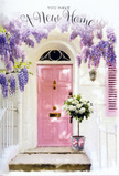 A sunlit entranceway in Cheam is captured here as a tender portrait of moving in and starting fresh. At the centre, a pale pink door glows with a soft, almost chalky finish, reflecting the warm light that spills across the steps and onto the nearby whitewashed wall. Framing the doorway, wisteria cascades in lush, trailing clusters of lavender and lilac, their hanging blooms like delicate tassels that brush the top of the frame and drift down toward the stone. Subtle shadows from the tangled vines pattern the façade in muted purples and greys, lending a sense of depth and gentle movement. On the step below, a simple grey bucket has been transformed into a welcoming arrangement, packed generously with creamy white roses. Each rose head is full and open, petals curling at the edges with velvety softness, interwoven with fresh, leafy greenery in soft, natural tones. A blush-pink ribbon encircles the bucket, tied into a small, graceful bow that mirrors the hue of the door and brings the whole composition together. The atmosphere is one of quiet joy and anticipation, as if a new set of keys has just been pressed into someone's hand after a meeting in Cheam Village, and this gift of flowers is waiting to greet them. Though the image is still, you can almost sense the mingled fragrance of roses and wisteria drifting across the threshold, offering an unspoken message of good luck, welcome, and the gentle thrill of a new chapter beginning.